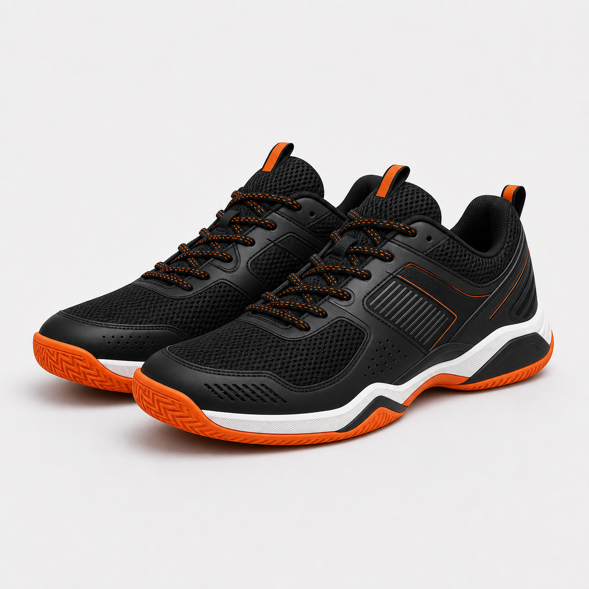 Black indoor court shoes with orange outsole and white midsole