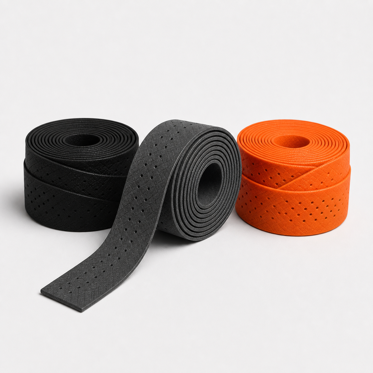 Racket grip tape set in black, grey and orange rolls