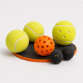 Mixed ball set with tennis balls, orange pickleball and squash balls on a tray